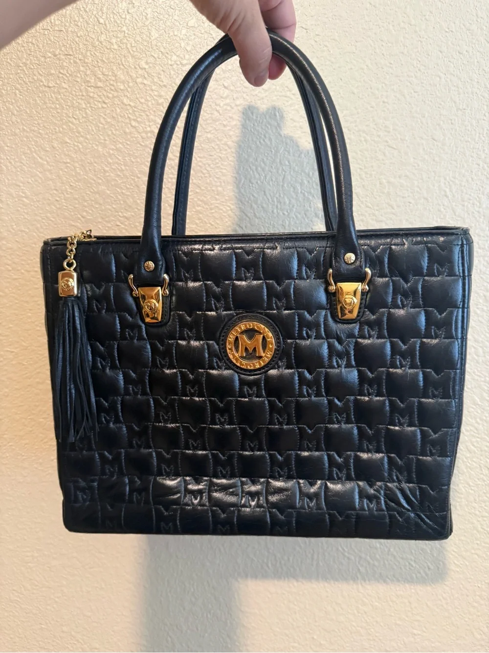 Metrocity Black Quilted Satchel with Gold Emblem and Tassel